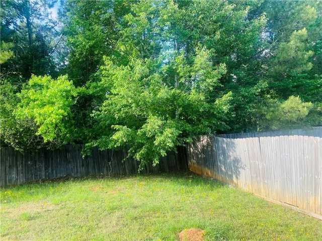 a view of a yard with a tree