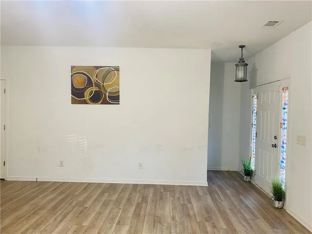 a view of water heater room with wooden floor