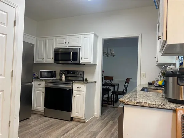 a kitchen with granite countertop a stove and a sink