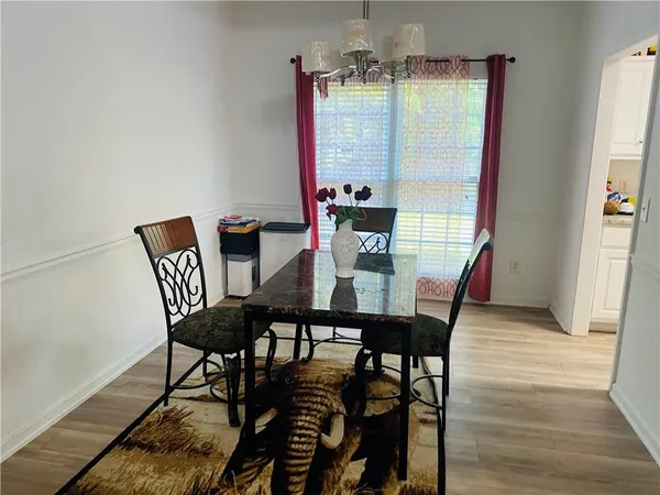 a view of a dining room with furniture and wooden floor
