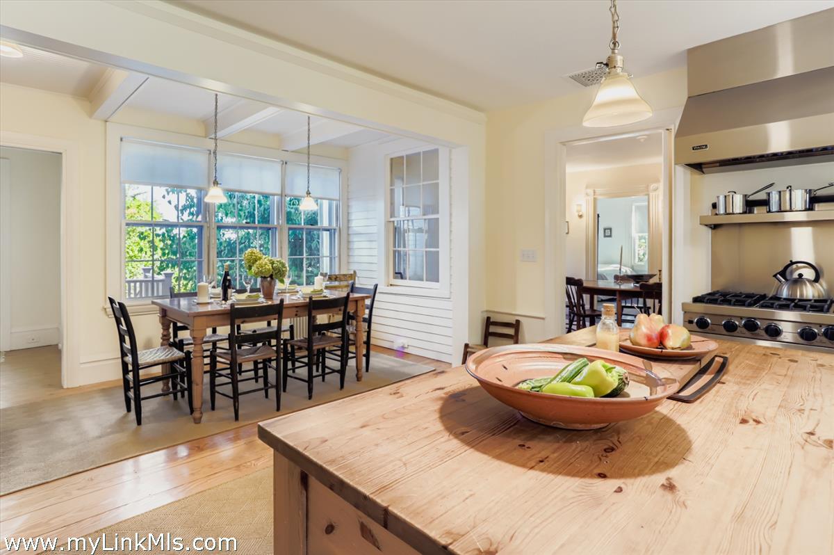27 Spring Street Vineyard Haven, MA 02568 - Photo 8 of 58 a view of a dining room and livingroom with furniture wooden floor a chandelier