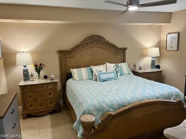 a bedroom with a bed and a lamp on the dresser