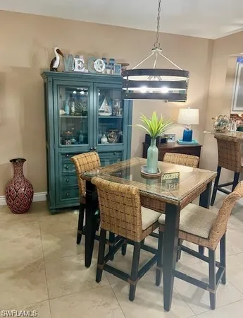 a dining room with furniture a chandelier and a rug