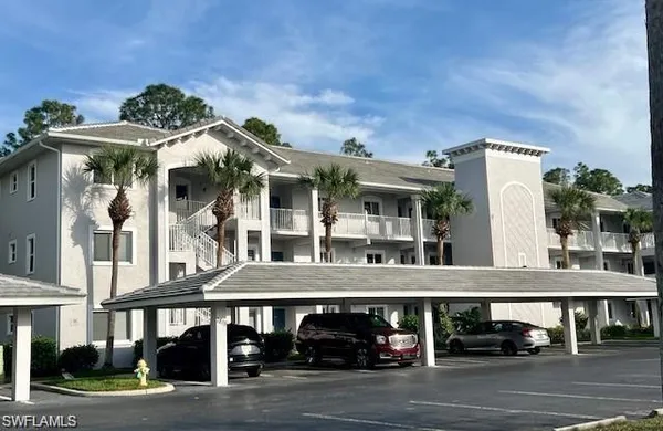 a view of a building with car parked