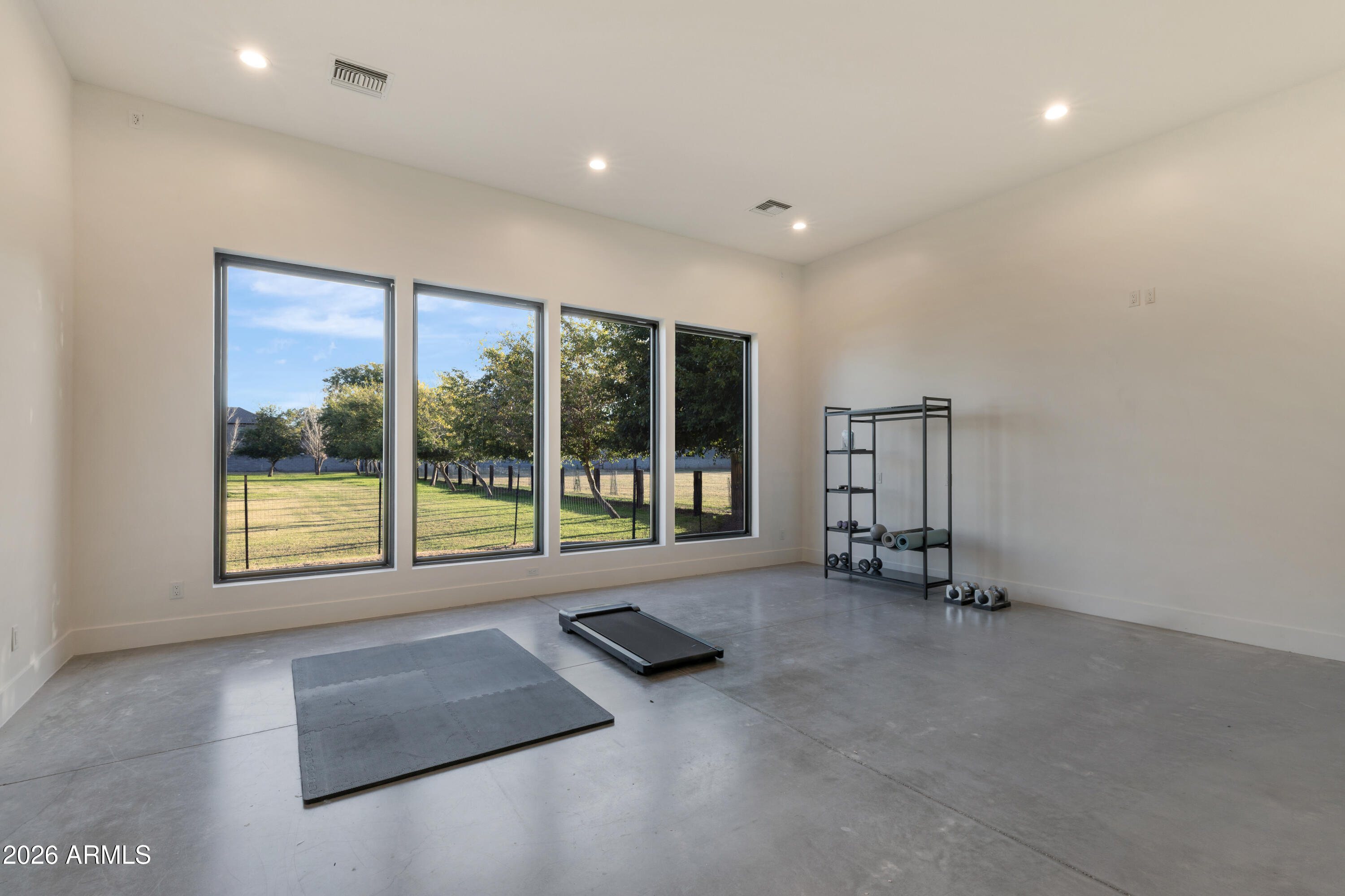 129 East Water Tank Road Gilbert, AZ 85296 - Photo 30 of 48 a view of an empty room with a fireplace and a large window