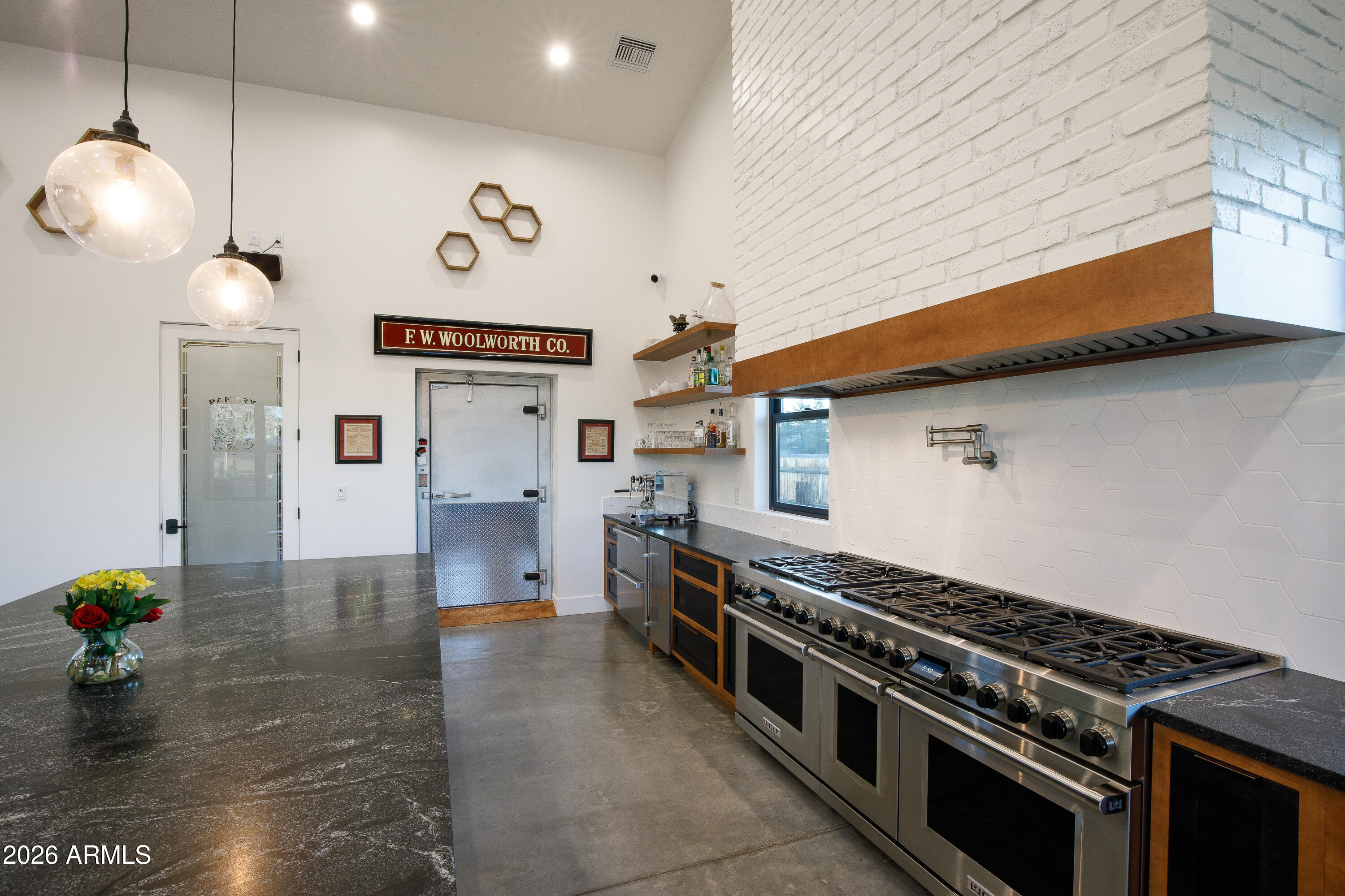 129 East Water Tank Road Gilbert, AZ 85296 - Photo 8 of 48 a kitchen with stainless steel appliances a stove a sink and a dining table