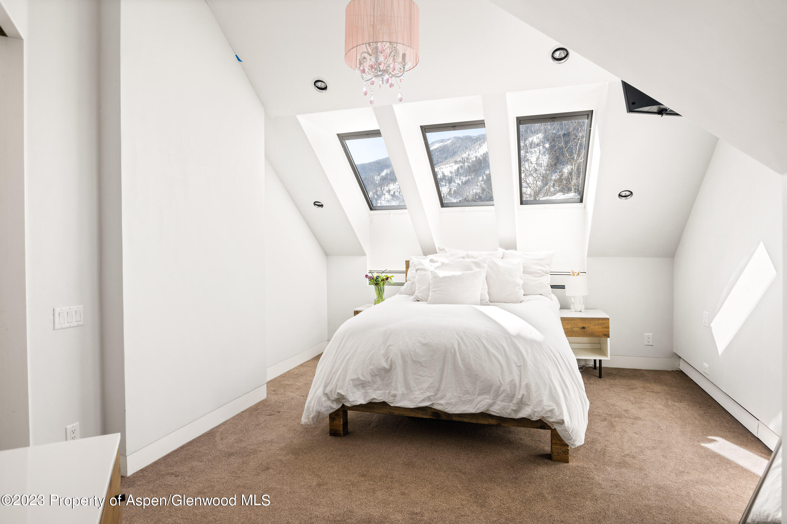 602 Mountain Laurel Drive Aspen, CO 81611 - Photo 18 of 23 a spacious bedroom with a bed and a window