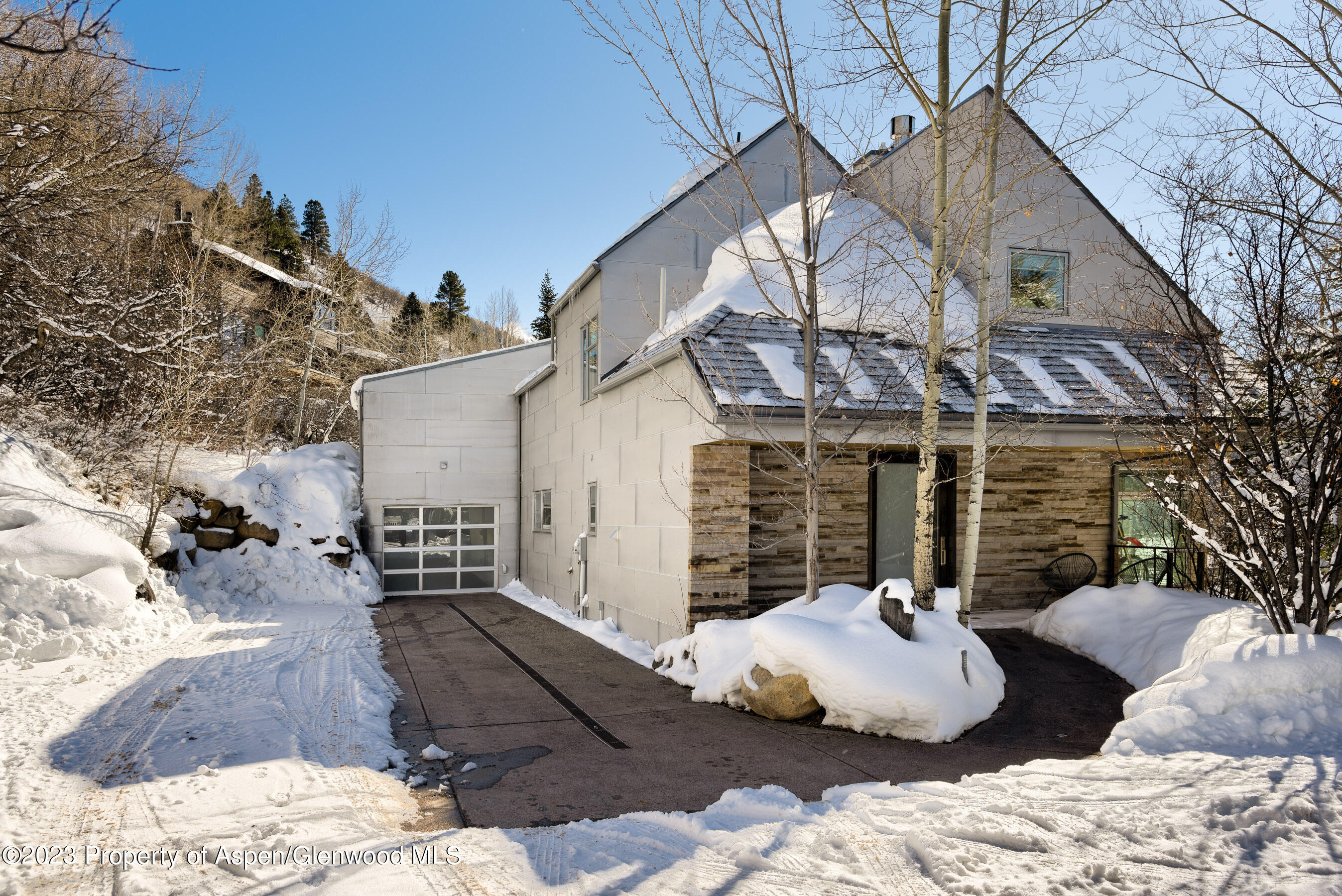 602 Mountain Laurel Drive Aspen, CO 81611 - Photo 23 of 23 a view of a patio with couches chairs and potted plants