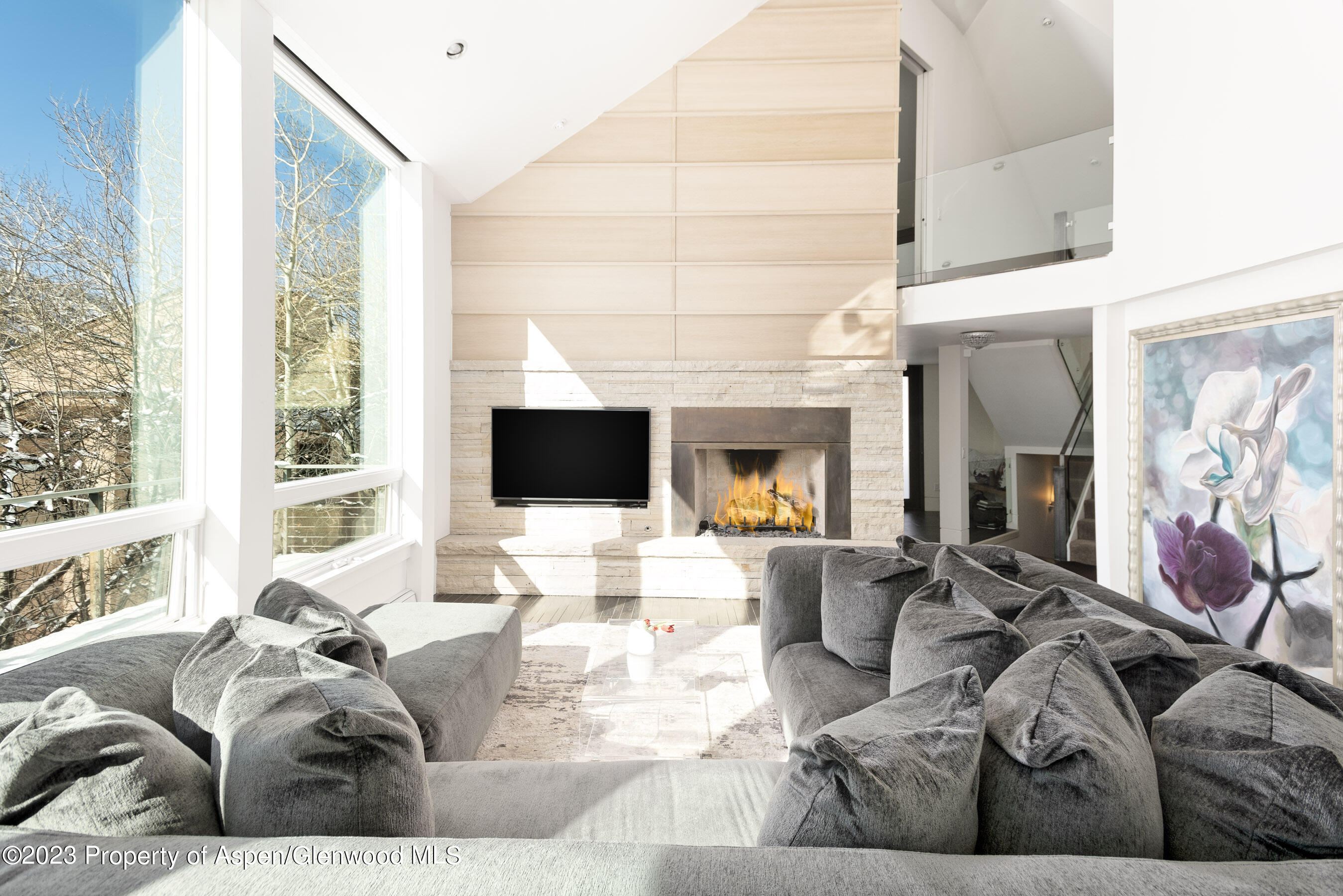 602 Mountain Laurel Drive Aspen, CO 81611 - Photo 5 of 23 a living room with furniture a flat screen tv and a large window