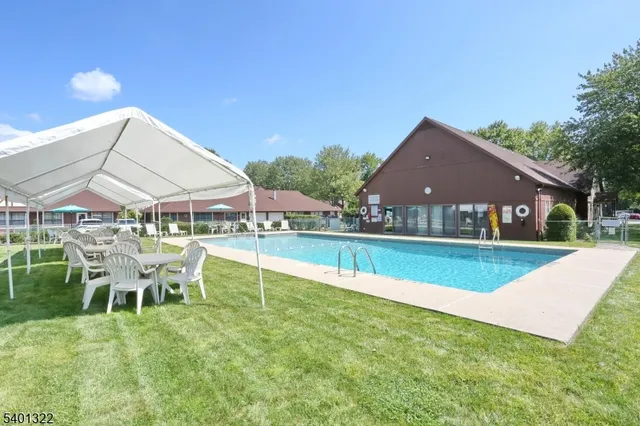 a view of house with swimming pool and chair