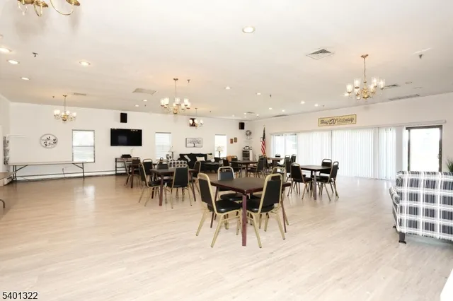 an open kitchen with lots of chairs and dining table