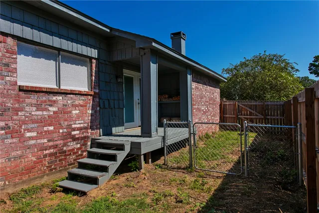 a backyard of a house with yard and outdoor seating