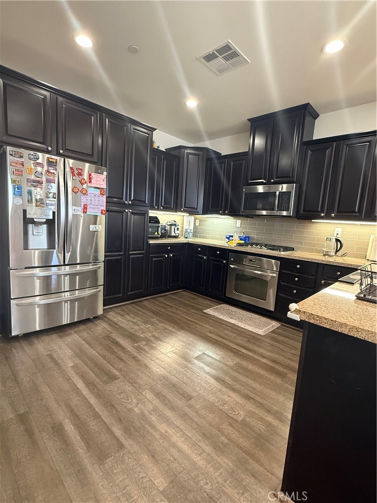 8041 City View Place Rancho Cucamonga, CA 91730 - Photo 6 of 21 a kitchen with stainless steel appliances granite countertop a refrigerator and a sink