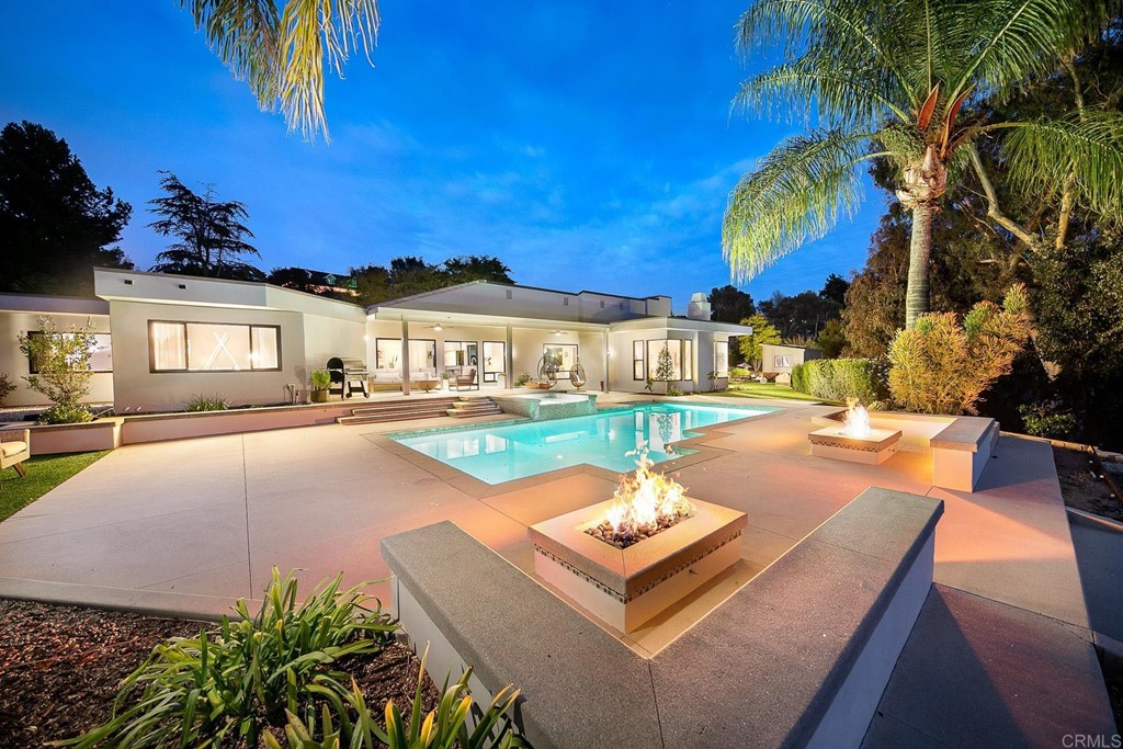 a view of a house with swimming pool and porch with furniture
