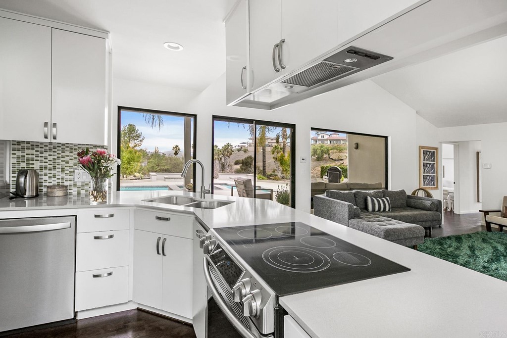 3095 Colley Lane Escondido, CA 92025 - Photo 13 of 51 a kitchen with a stove a sink and cabinets