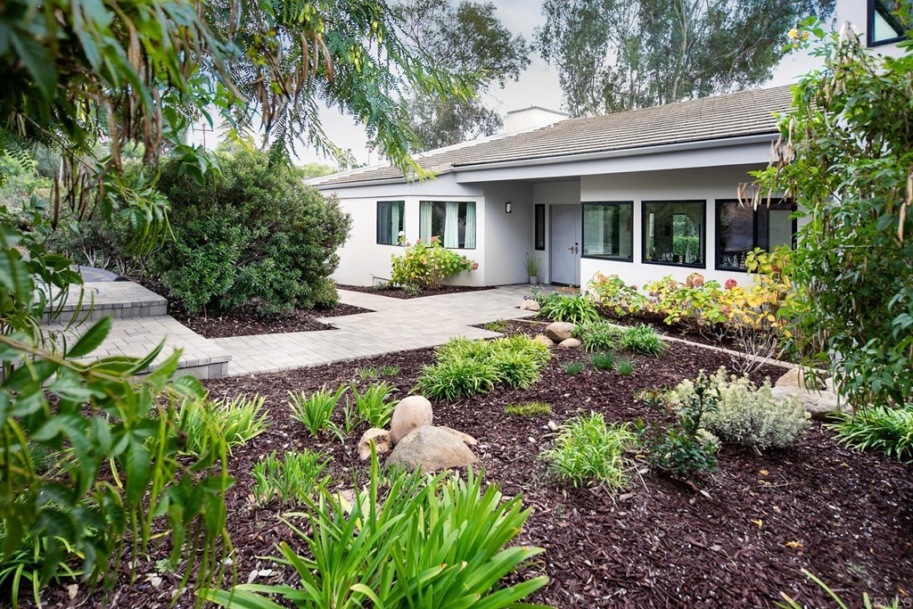 3095 Colley Lane Escondido, CA 92025 - Photo 4 of 51 a front view of a house with a yard and potted plants