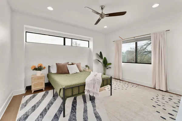 a bedroom with a bed and a window