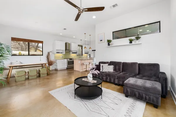 a kitchen with kitchen island a stove a sink and a refrigerator