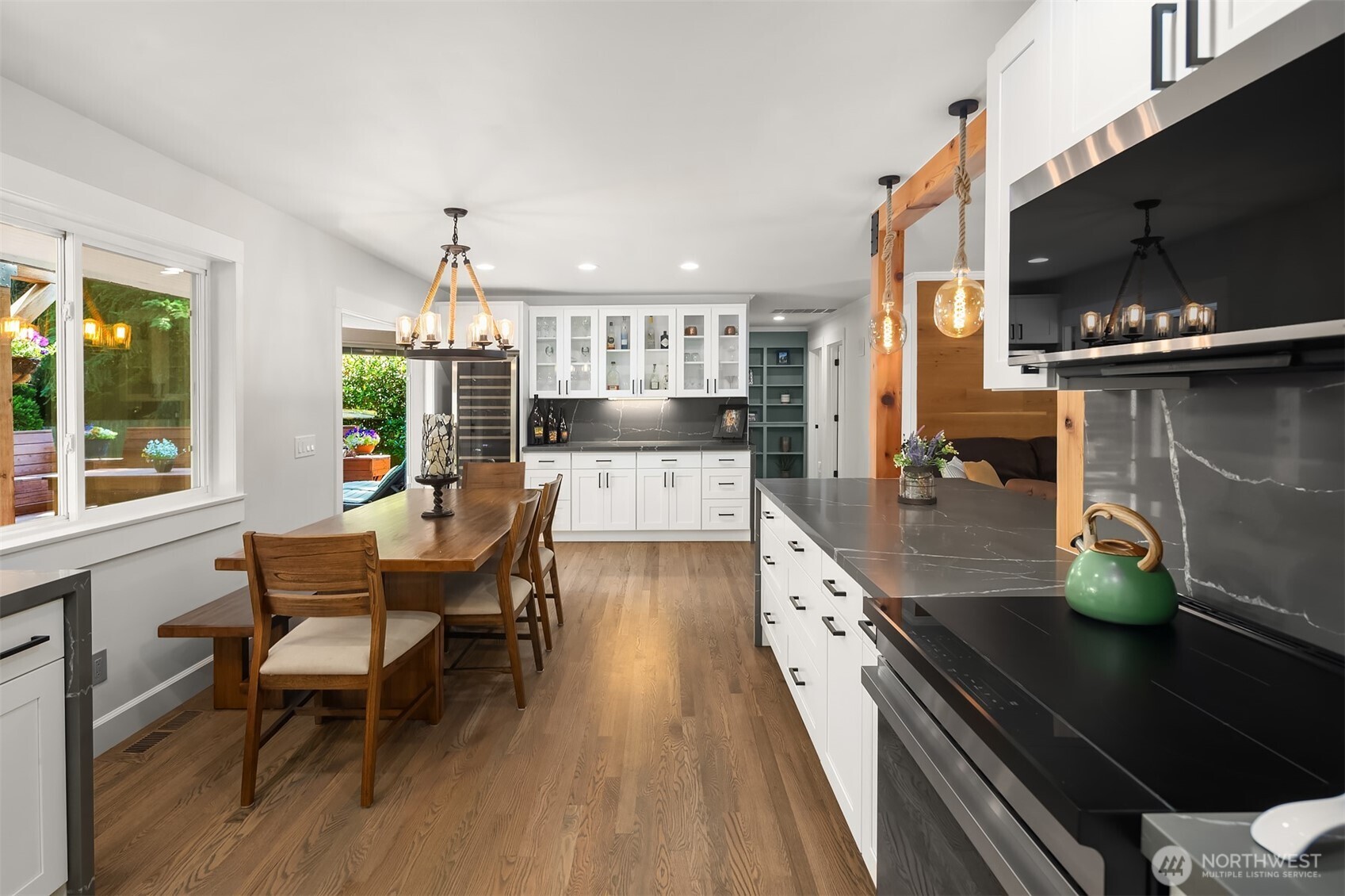7245 Northeast 170th Street Kenmore, WA 98028 - Photo 15 of 35 a kitchen with a table chairs and flat screen tv