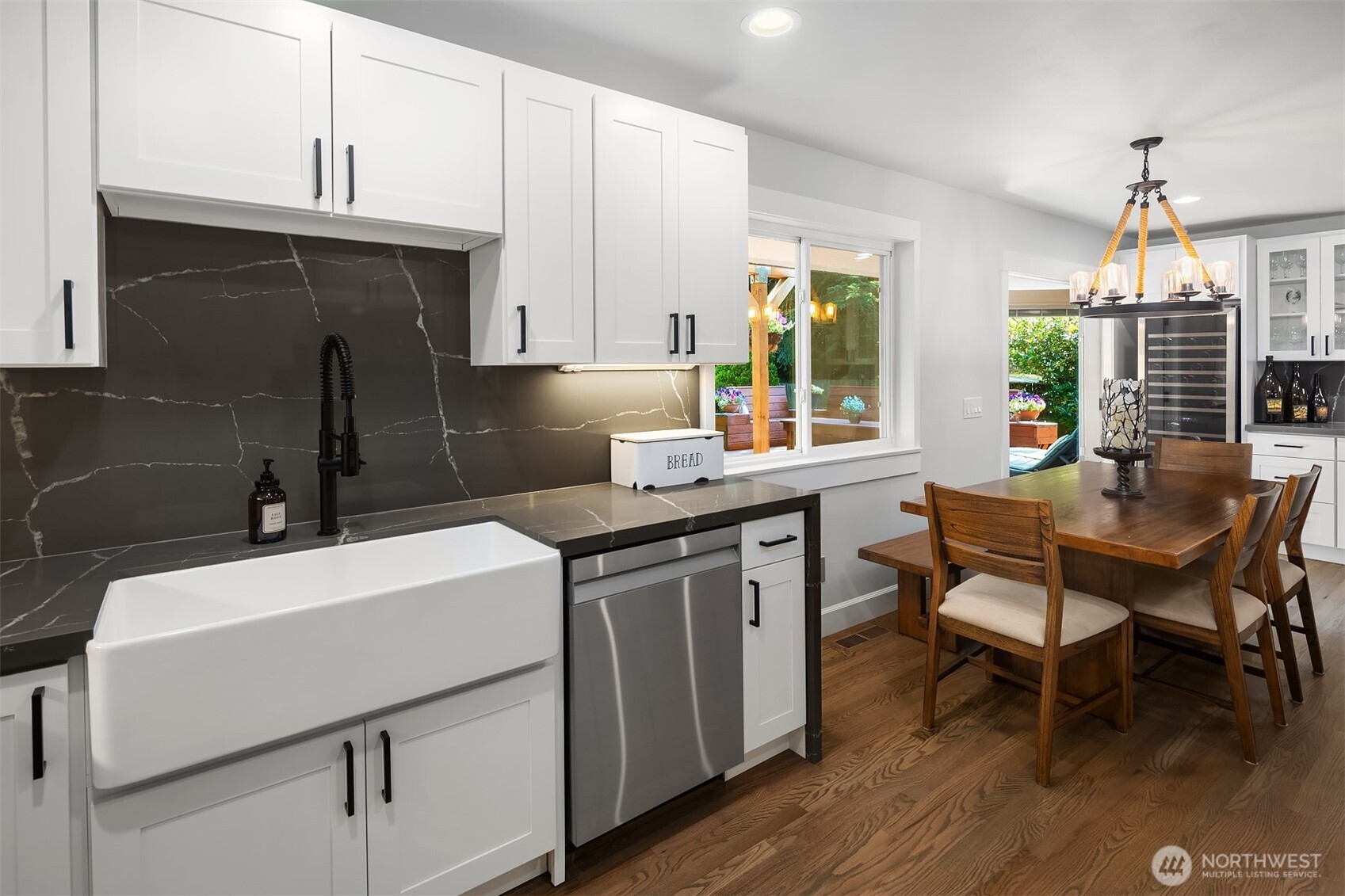 7245 Northeast 170th Street Kenmore, WA 98028 - Photo 17 of 35 a kitchen that has a sink a table and chairs in it