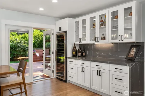 a kitchen with granite countertop a stove and cabinets