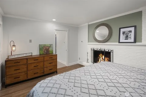 a spacious bedroom with a bed and a fireplace