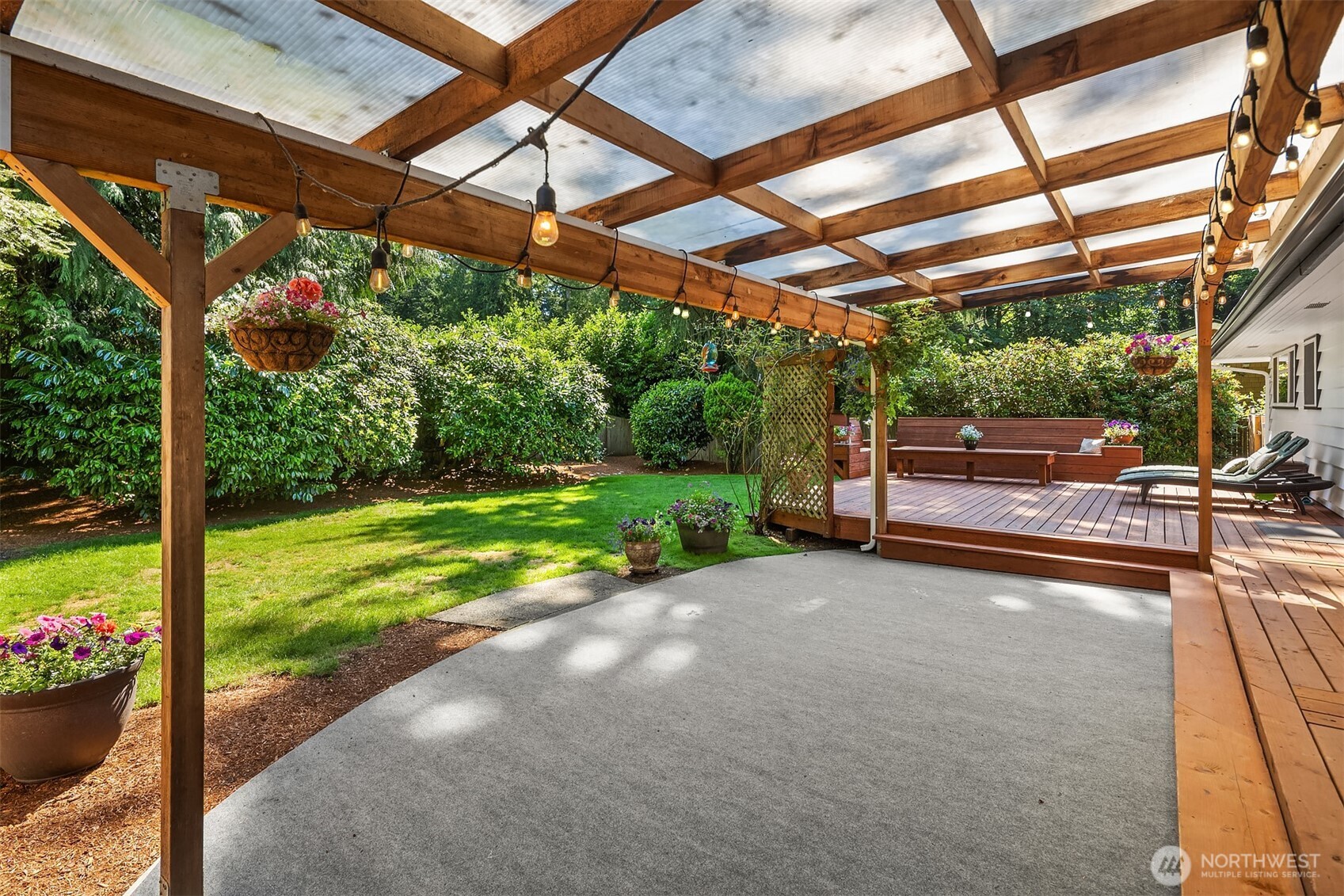 7245 Northeast 170th Street Kenmore, WA 98028 - Photo 30 of 35 a view of a patio with a table and chairs under an umbrella