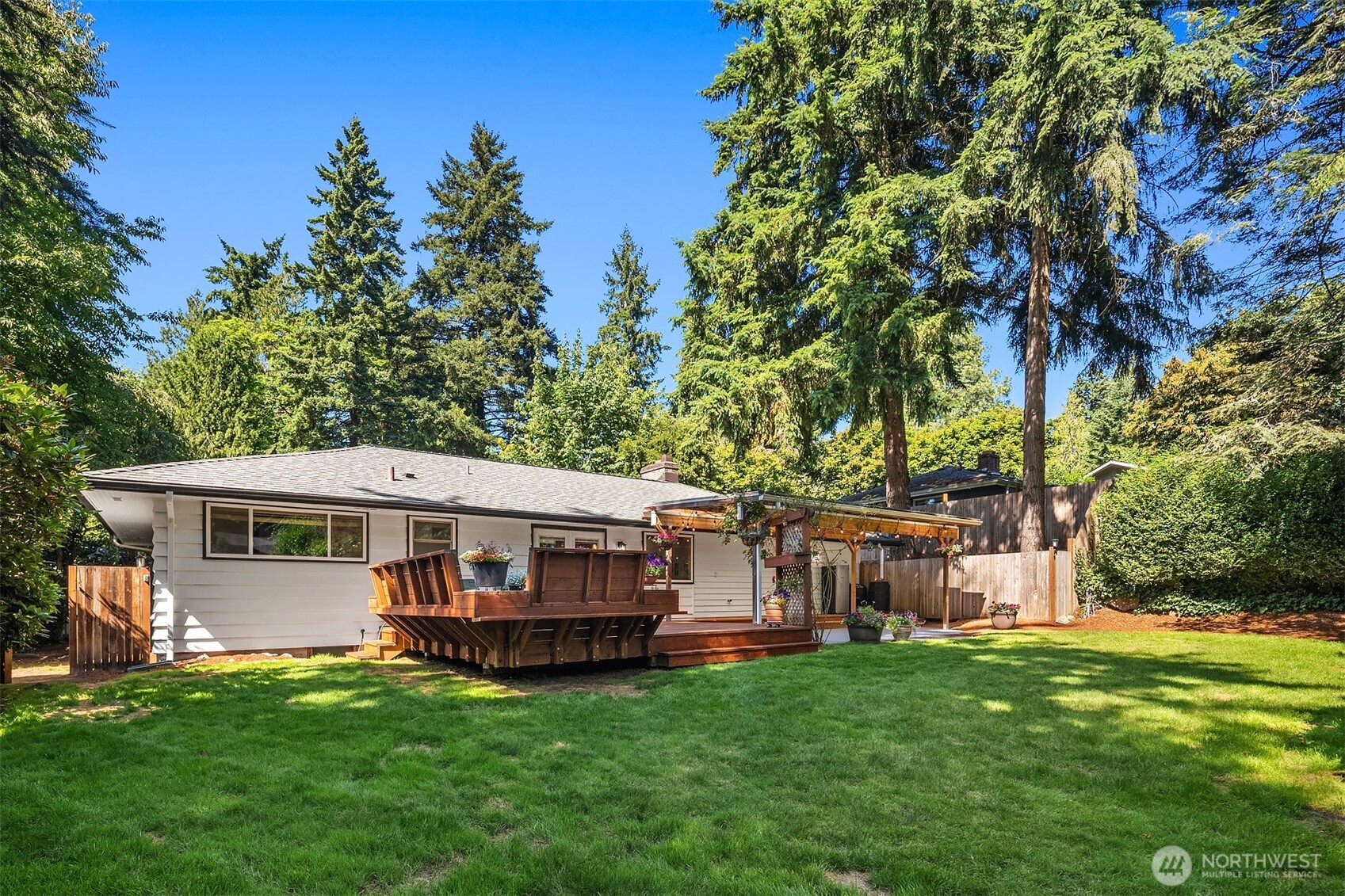 7245 Northeast 170th Street Kenmore, WA 98028 - Photo 31 of 35 a view of house with garden and tall trees