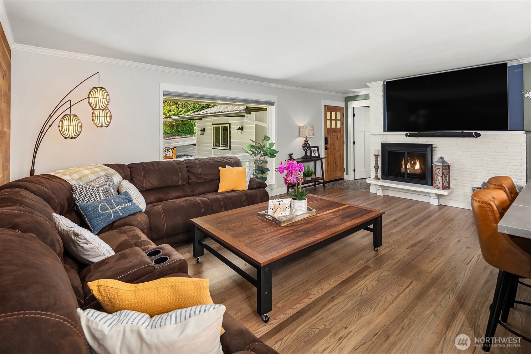 7245 Northeast 170th Street Kenmore, WA 98028 - Photo 6 of 35 a living room with furniture a flat screen tv and a fireplace
