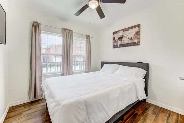 a bedroom with a bed and wooden floor