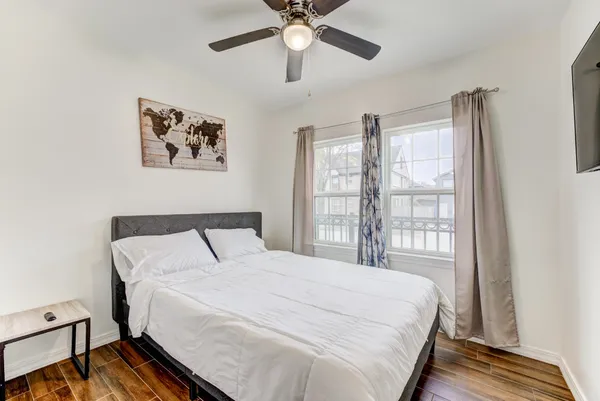 a bedroom with a large bed and a chandelier