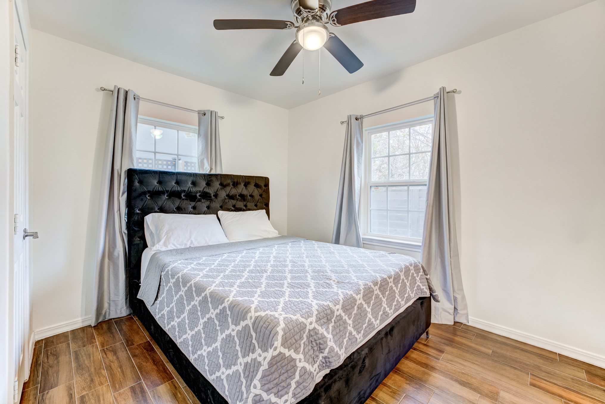 2720 Truxillo Street, Unit 5 Houston, TX 77004 - Photo 14 of 30 a bedroom with a bed and wooden floor