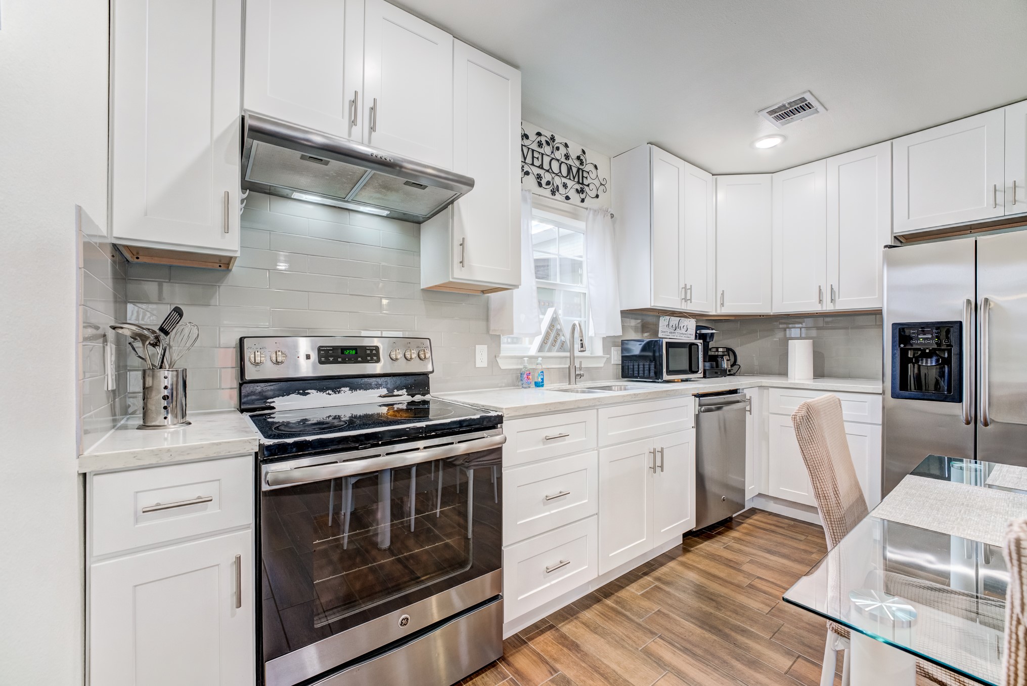 2720 Truxillo Street, Unit 5 Houston, TX 77004 - Photo 8 of 30 a kitchen with cabinets stainless steel appliances and wooden floor