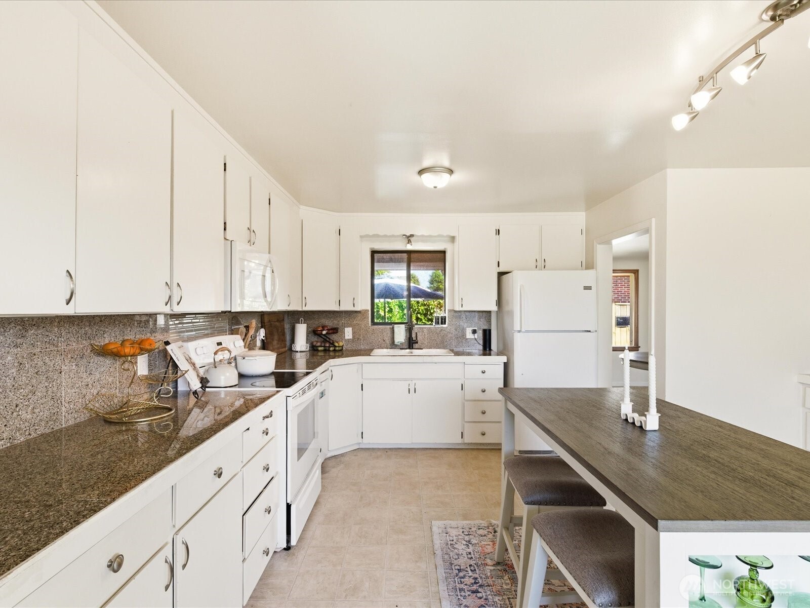 1417 Maple Street Sumner, WA 98390 - Photo 28 of 40 a kitchen with white cabinets sink and white appliances