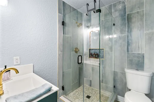 a bathroom with a shower and mirror