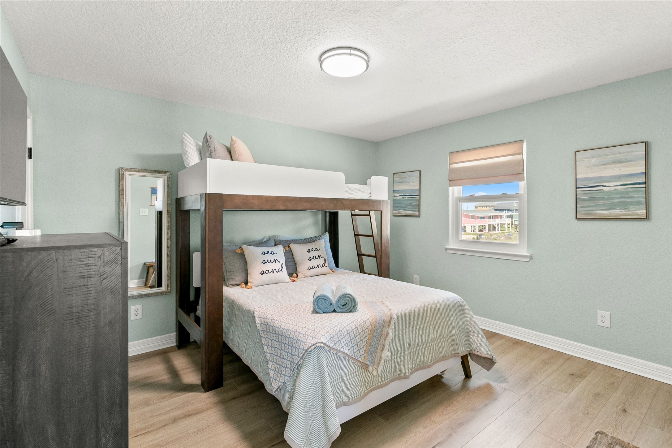 1213 Sargasso Circle Surfside Beach, TX 77541 - Photo 30 of 40 a bedroom with a bed and wooden floor