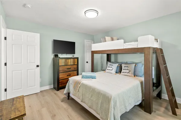a bedroom with a bed and a flat screen tv
