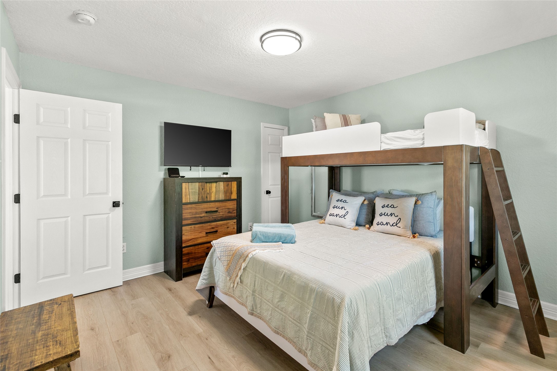 1213 Sargasso Circle Surfside Beach, TX 77541 - Photo 31 of 40 a bedroom with a bed and a flat screen tv