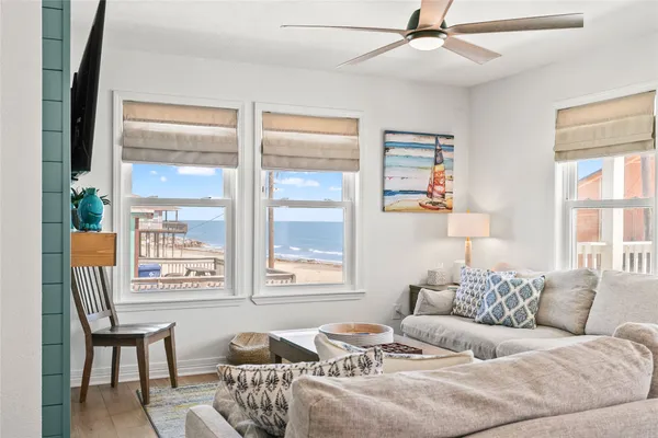 a living room with furniture and two window