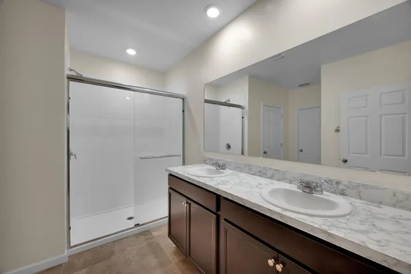 a white toilet sitting next to a white wall