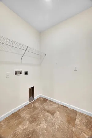 a kitchen with a sink a counter top space stainless steel appliances cabinets and a wooden floor