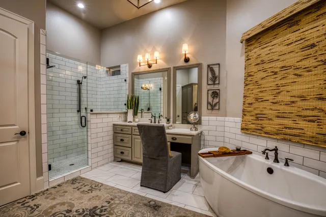 a bathroom with a tub sink and mirror