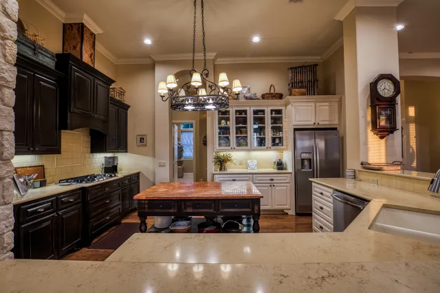 a kitchen with refrigerator and cabinets
