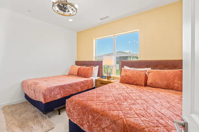 a kitchen with stainless steel appliances kitchen island a table chairs in it and wooden floors