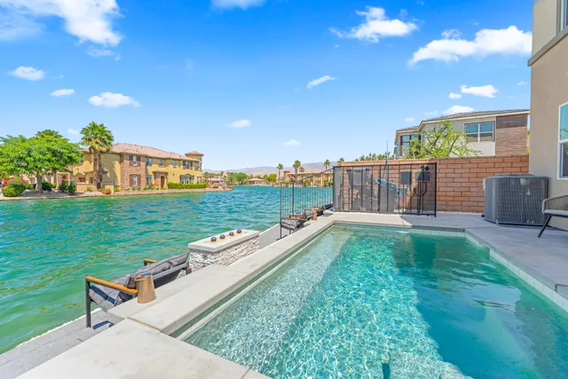 a bedroom with two beds and a large window