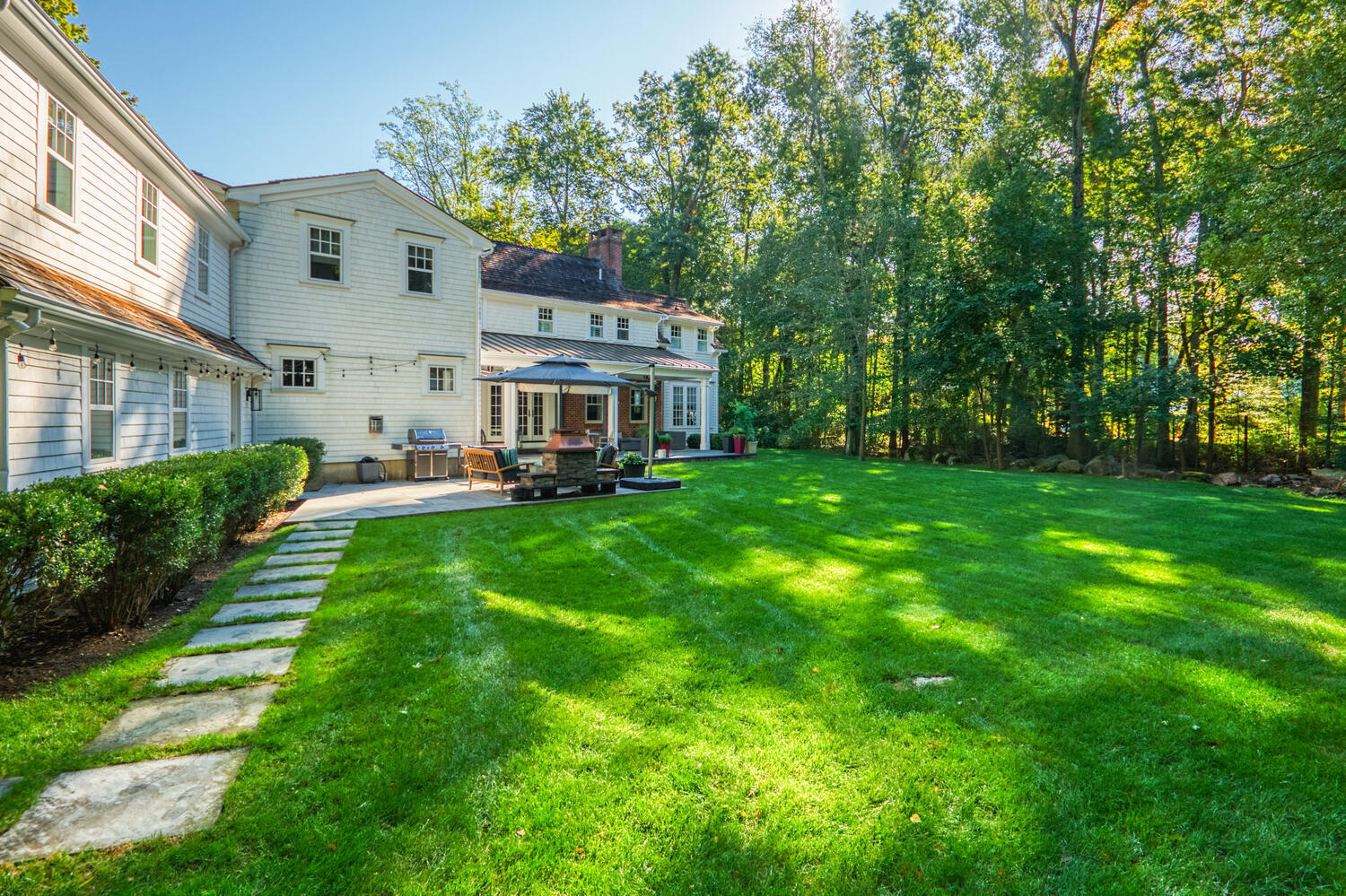 293 Hollow Tree Ridge Road Darien, CT 06820 - Photo 38 of 46 a front view of a house with a yard and trees