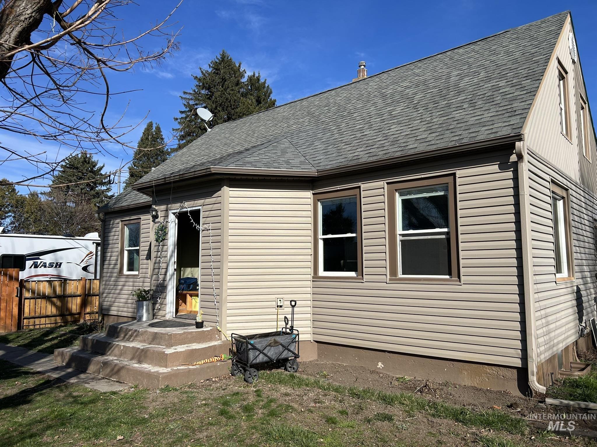 Back of house with roof with shingles