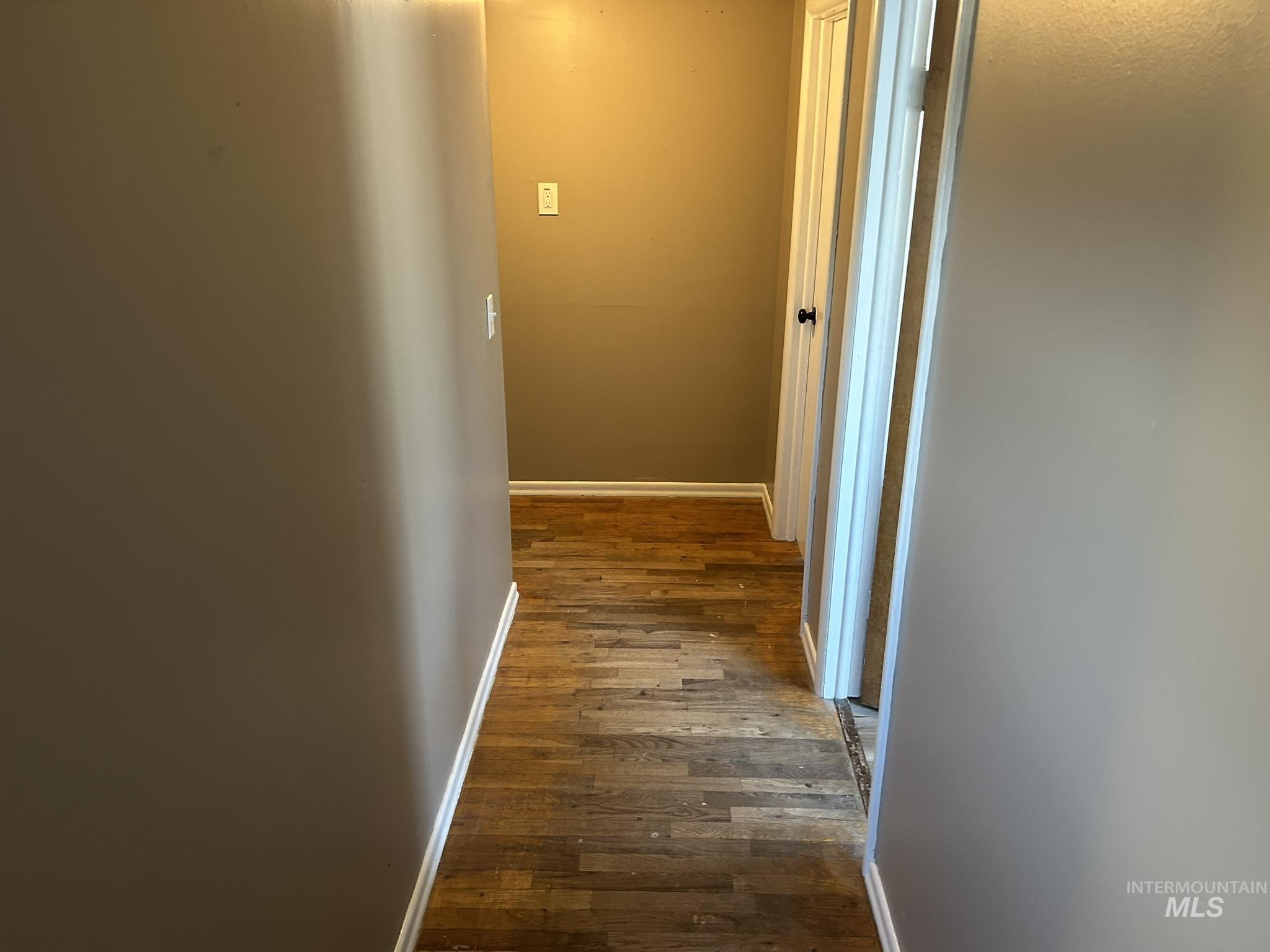 3837 16th Street Lewiston, ID 83501 - Photo 11 of 42 Hallway featuring baseboards and dark wood finished floors