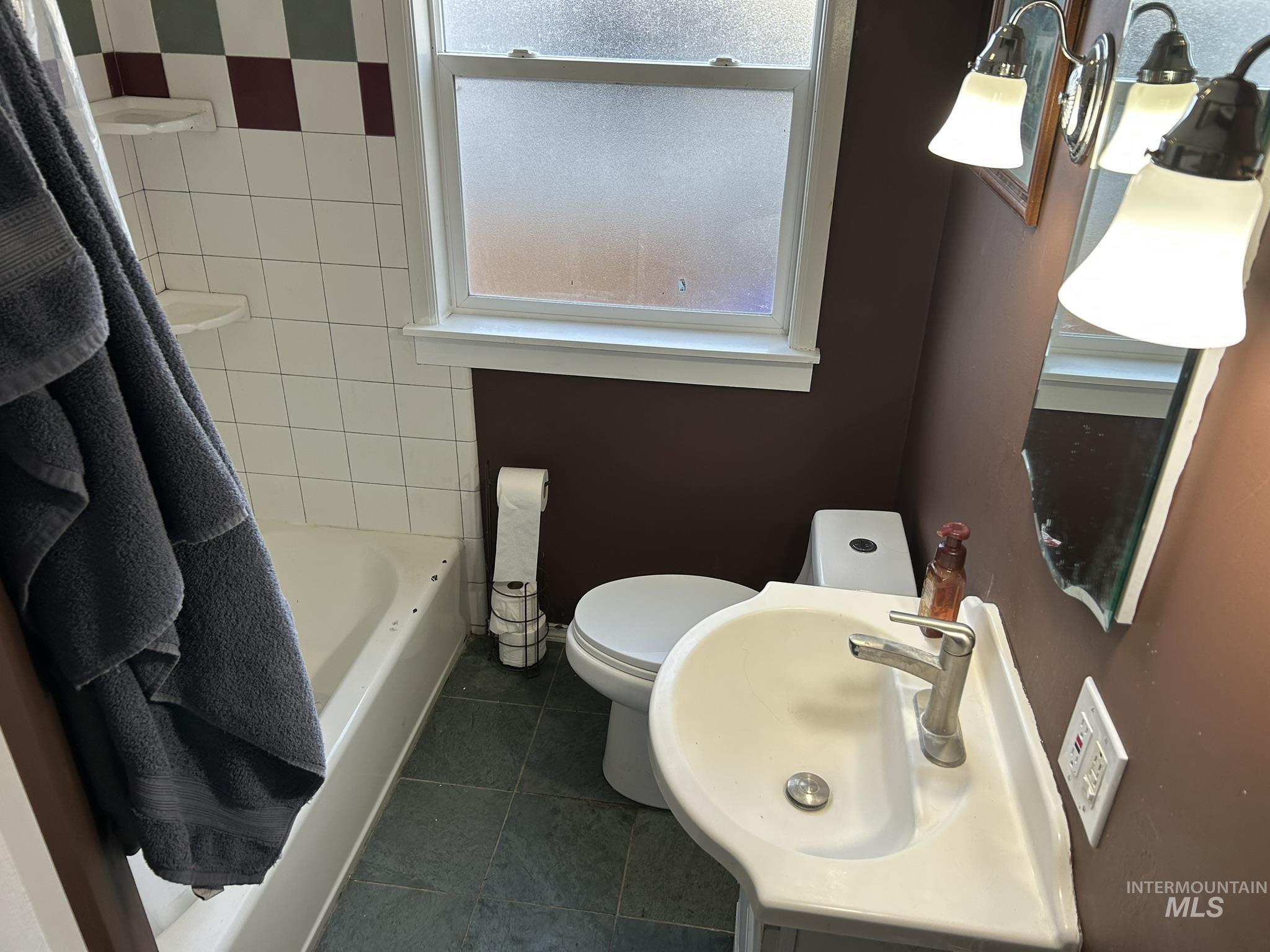 3837 16th Street Lewiston, ID 83501 - Photo 12 of 45 Bathroom with dark tile patterned flooring, a bath, and vanity