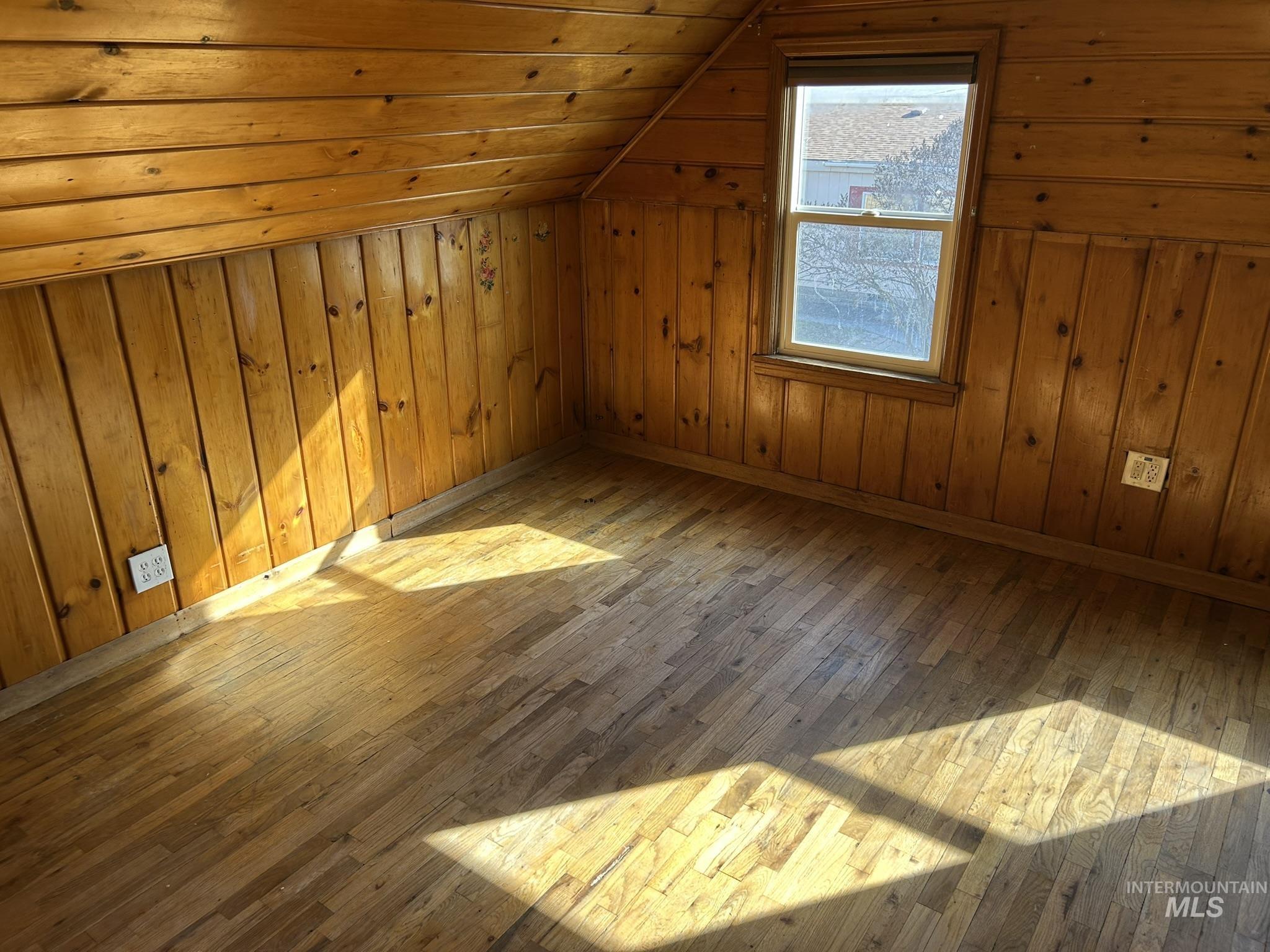 3837 16th Street Lewiston, ID 83501 - Photo 17 of 42 Additional living space featuring wood walls, hardwood / wood-style floors, and a vaulted wooden ceiling